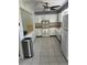 Spacious kitchen with stainless steel trash can and white appliances at 1660 Caledonia Dr, Palm Harbor, FL 34684