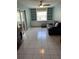 Spacious living room featuring built in shelving, sliding doors to a balcony, and tile flooring at 1660 Caledonia Dr, Palm Harbor, FL 34684