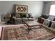 Comfortable living room area with sofas, patterned rug, and gray walls at 1660 Caledonia Dr, Palm Harbor, FL 34684