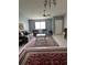 Cozy living room with neutral walls, ceiling fan, and multiple area rugs at 1660 Caledonia Dr, Palm Harbor, FL 34684