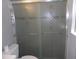 Bathroom with frosted shower doors with decorative etched patterns at 1660 Caledonia Dr, Palm Harbor, FL 34684