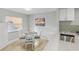 Bright dining area featuring a round table with seating for four and natural light from a window at 17035 Gulf Blvd # 202, North Redington Beach, FL 33708