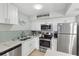 Well-equipped kitchen featuring stainless steel appliances, white cabinets, and ample counter space at 17035 Gulf Blvd # 202, North Redington Beach, FL 33708