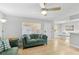 Cozy living room with comfortable seating, a ceiling fan, and a connected dining area with a table set for four at 17035 Gulf Blvd # 202, North Redington Beach, FL 33708