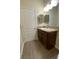 Well-lit bathroom featuring a vanity with a sink and a wood-look floor at 1706 Trailwater St, Ruskin, FL 33570