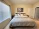 Inviting bedroom featuring a bed, blinds, and an en-suite bathroom and closet access at 1706 Trailwater St, Ruskin, FL 33570
