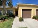 Inviting townhome showcasing a well-kept lawn, landscaping, and a single-car garage at 1706 Trailwater St, Ruskin, FL 33570