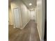 Long hallway with multiple doors and overhead lighting at 1706 Trailwater St, Ruskin, FL 33570