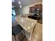 Bright kitchen boasts granite countertops, stainless steel appliances and a breakfast bar at 1706 Trailwater St, Ruskin, FL 33570