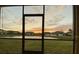 Patio view showcasing the sunset over the pond and the surrounding neighborhood at 1706 Trailwater St, Ruskin, FL 33570