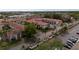 Aerial view of a condo community with mature trees and red tile roofs at 19029 Us Highway 19 N # 2-12, Clearwater, FL 33764