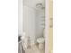 Small bathroom with toilet, towel rack, and shelves for storage at 19029 Us Highway 19 N # 2-12, Clearwater, FL 33764