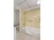 Bathroom featuring a walk-in tub, accessible shower head, and white tile flooring at 19029 Us Highway 19 N # 2-12, Clearwater, FL 33764