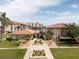 Exterior shot of the clubhouse featuring a beautifully maintained landscape and inviting entrance at 19029 Us Highway 19 N # 2-12, Clearwater, FL 33764