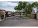 Secured community gate entrance with mature landscaping and lush green surroundings at 19029 Us Highway 19 N # 2-12, Clearwater, FL 33764