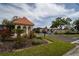 A view of the 'Imperial Cove' entrance sign with lush landscaping at 19029 Us Highway 19 N # 2-12, Clearwater, FL 33764