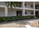 Exterior view of a two-story condo with a front door and balcony at 19029 Us Highway 19 N # 2-12, Clearwater, FL 33764