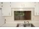 Functional kitchen design featuring a stainless steel sink and breakfast bar pass-through at 19029 Us Highway 19 N # 2-12, Clearwater, FL 33764