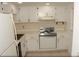 Kitchen with tile floors, white cabinetry and white appliances at 19029 Us Highway 19 N # 2-12, Clearwater, FL 33764