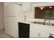 Efficient kitchen layout featuring ample storage, double sinks, and updated appliances at 19029 Us Highway 19 N # 2-12, Clearwater, FL 33764