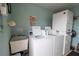 Laundry room features a sink, two washers, and a dryer at 19029 Us Highway 19 N # 2-12, Clearwater, FL 33764