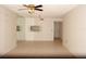 Open living room with tile floors, ceiling fan, and mirrored accent wall at 19029 Us Highway 19 N # 2-12, Clearwater, FL 33764