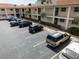 Aerial view of a condo parking lot, shows parking spots and surrounding landscaping at 19029 Us Highway 19 N # 2-12, Clearwater, FL 33764