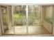 Enclosed patio has tile flooring and access to the outside at 19029 Us Highway 19 N # 2-12, Clearwater, FL 33764