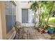 View of patio with two chairs, potted plants and natural light at 19029 Us Highway 19 N # 2-12, Clearwater, FL 33764
