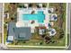A bird's eye view of a community pool area featuring well-maintained landscaping, lounge chairs, and cabanas at 19398 Great Intention Way, Lutz, FL 33558