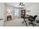 Well-lit bedroom with neutral tones featuring a ceiling fan and functional desk space at 19398 Great Intention Way, Lutz, FL 33558
