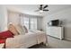 Comfortable bedroom with a ceiling fan, large window and stylish furnishings at 19398 Great Intention Way, Lutz, FL 33558