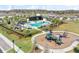 An aerial view showcasing the resort-style community pool with lounge seating and playground in a Gathering-friendly neighborhood at 19398 Great Intention Way, Lutz, FL 33558
