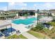 A stunning community pool area with ample seating, lush greenery, and a modern pavilion, creating a perfect relaxation spot at 19398 Great Intention Way, Lutz, FL 33558