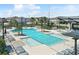 A pristine community pool featuring multiple water features, lounge chairs, and shaded areas, ideal for relaxation and recreation at 19398 Great Intention Way, Lutz, FL 33558