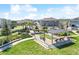 A welcoming community space with manicured lawns, seating areas, and recreational facilities under a bright blue sky at 19398 Great Intention Way, Lutz, FL 33558