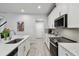 Bright eat-in kitchen featuring white cabinets, granite counters, stainless appliances at 19398 Great Intention Way, Lutz, FL 33558