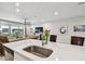 Spacious kitchen island features sink, counter space, and view to living room at 19398 Great Intention Way, Lutz, FL 33558