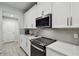 Eat-in kitchen features white cabinets, granite counters, stainless appliances at 19398 Great Intention Way, Lutz, FL 33558