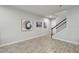 Open-concept living room features beautiful wood-look tile flooring and staircase access at 19398 Great Intention Way, Lutz, FL 33558