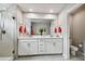 Stylish bathroom with dual sinks, a large mirror, and a glass enclosed shower at 19398 Great Intention Way, Lutz, FL 33558