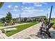 Outdoor seating area with lawn games, string lights and manicured landscaping for entertaining guests at 19398 Great Intention Way, Lutz, FL 33558