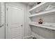 Walk-in pantry features ample shelving and storage space at 19398 Great Intention Way, Lutz, FL 33558