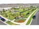 An aerial view of bocce ball court, seating and manicured lawns in this community at 19398 Great Intention Way, Lutz, FL 33558