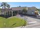 Exterior shot of building featuring an arched entrance, flagpole, and lush landscaping at 2070 World Parkway Blvd # 34, Clearwater, FL 33763