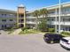 Exterior view of a condominium building featuring a central courtyard and ample parking at 2070 World Parkway Blvd # 34, Clearwater, FL 33763