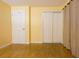 Bedroom has natural light, laminate wood flooring, and closet with sliding doors at 2118 Ne Coachman Rd, Clearwater, FL 33765