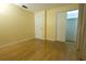 Bedroom boasts natural light, laminate wood flooring, and closet with sliding doors at 2118 Ne Coachman Rd, Clearwater, FL 33765