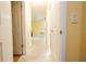 Hallway with neutral walls and white doors leads to a naturally lit room at 2118 Ne Coachman Rd, Clearwater, FL 33765