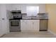 Modern kitchen featuring stainless steel appliances, white cabinets, and stylish backsplash for a sleek and functional design at 2118 Ne Coachman Rd, Clearwater, FL 33765